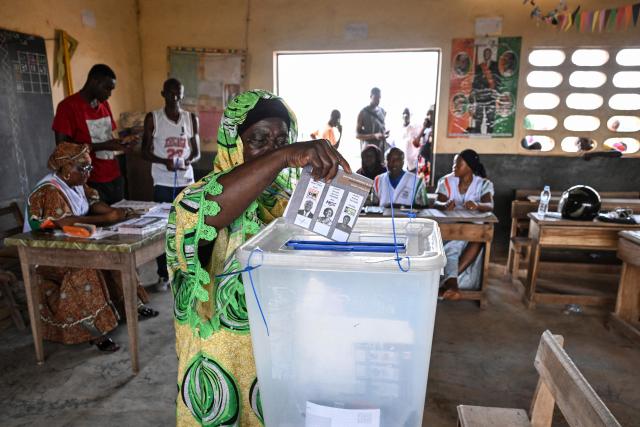 A voter casts her ballot at a polling station in Agboville on October 25, 2025 during Ivory Coast's presidential elections. (Photo by Issouf SANOGO / AFP)