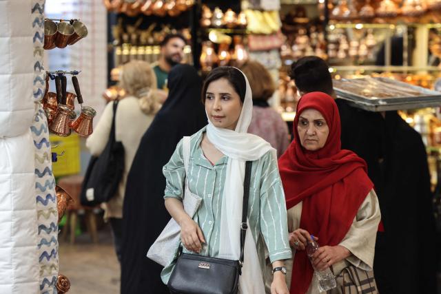 Women shop at Tajrish Bazaar in the Iranian capital Tehran on October 25, 2025. (Photo by ATTA KENARE / AFP)