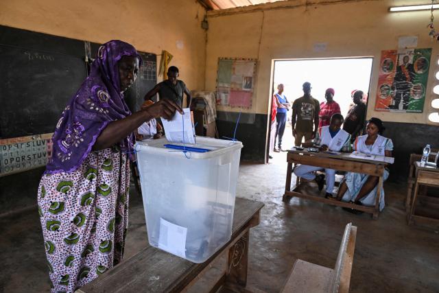 A voter casts her ballot at a polling station in Agboville on October 25, 2025 during Ivory Coast's presidential elections. (Photo by Issouf SANOGO / AFP)