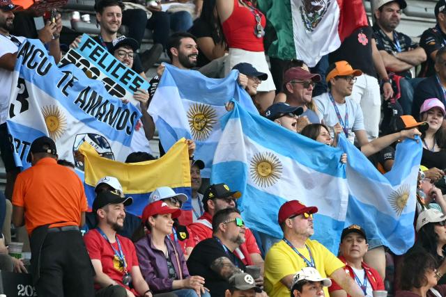 Fans show Argentine flags ahead of the third practice session of the Mexico City Formula One Grand Prix at the Hermanos Rodriguez racetrack in Mexico City on October 25, 2025. (Photo by Yuri CORTEZ / AFP)