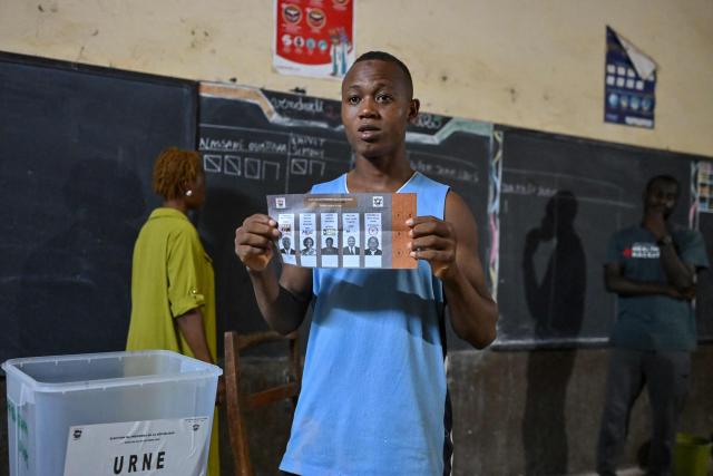 Independent Electoral Commission of Ivory Coast (CEI) officials count votes at a polling station in Dabou on October 25, 2025 after polls closed during Ivory Coast's presidential elections. (Photo by Issouf SANOGO / AFP)