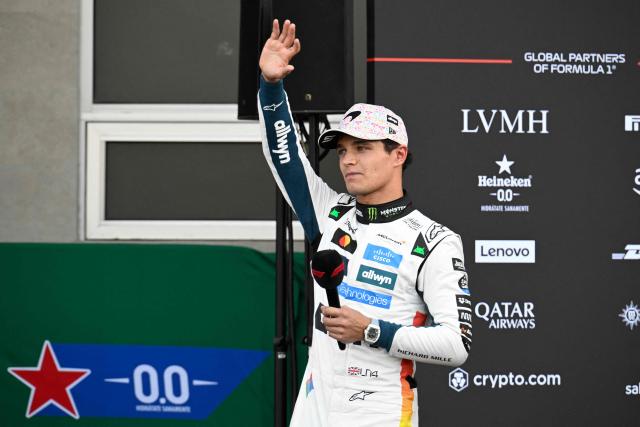McLaren's British driver Lando Norris waves fans after getting the pole position during the qualifying session of the Mexico City Formula One Grand Prix at the Hermanos Rodriguez racetrack in Mexico City on October 25, 2025. (Photo by Alfredo ESTRELLA / POOL / AFP)