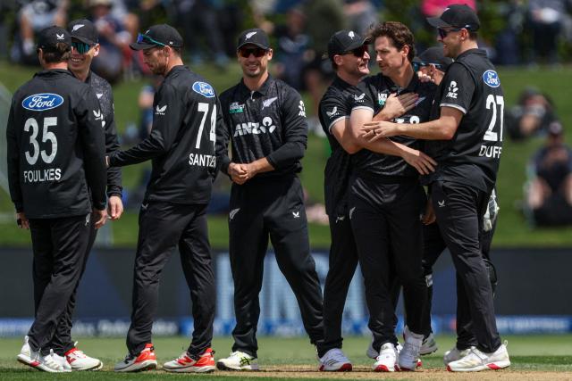 New Zealand's players celebrate a wicket during the first one-day international (ODI) cricket match between New Zealand and England at Bay Oval in Tauranga on October 26, 2025. (Photo by DJ MILLS / AFP)