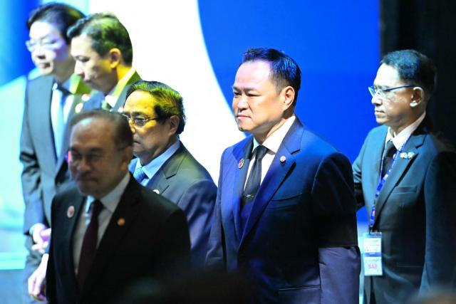 Thailand's Prime Minister Anutin Charnvirakul (C) arrives for the opening ceremony of the 47th Association of Southeast Asian Nations (ASEAN) Summit in Kuala Lumpur on October 26, 2025. (Photo by MOHD RASFAN / AFP)