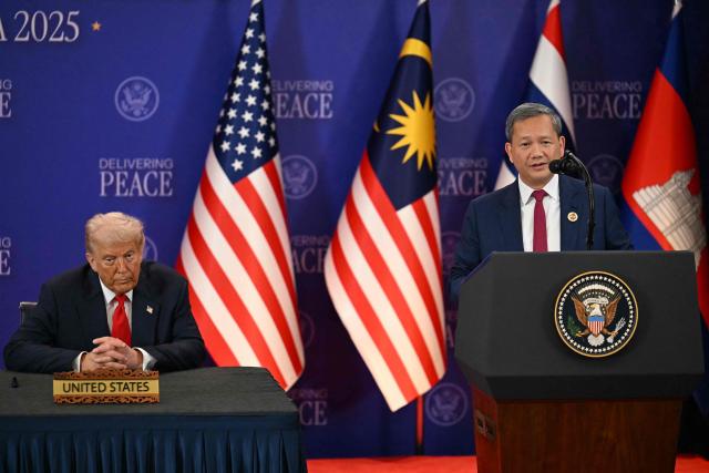 US President Donald Trump (L) listens to Cambodia's Prime Minister Hun Manet speak ahead of the ceremonial signing of a ceasefire agreement between Thailand and Cambodia on the sidelines of the 47th Association of Southeast Asian Nations (ASEAN) Summit in Kuala Lumpur on October 26, 2025. (Photo by MOHD RASFAN / POOL / AFP)