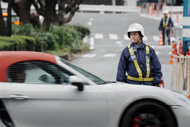 A police officer stands guard on a street leading to the US embassy in Tokyo on October 26, 2025, ahead of US President Donald Trump's visit to Japan. (Photo by Kazuhiro NOGI / AFP)