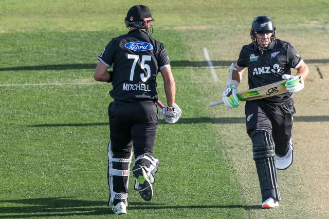 New Zealand's Tom Latham and Daryl Mitchell run between the wickets during the first one-day international (ODI) cricket match between New Zealand and England at Bay Oval in Tauranga on October 26, 2025. (Photo by DJ MILLS / AFP)