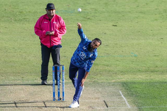 England's Adil Rashid bowls during the first one-day international (ODI) cricket match between New Zealand and England at Bay Oval in Tauranga on October 26, 2025. (Photo by DJ MILLS / AFP)