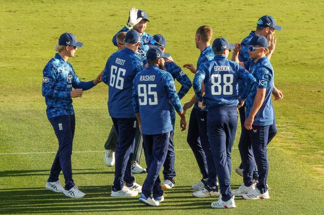 England's players celebrate a wicket during the first one-day international (ODI) cricket match between New Zealand and England at Bay Oval in Tauranga on October 26, 2025. (Photo by DJ MILLS / AFP)