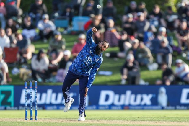 England's Adil Rashid bowls during the first one-day international (ODI) cricket match between New Zealand and England at Bay Oval in Tauranga on October 26, 2025. (Photo by DJ MILLS / AFP)