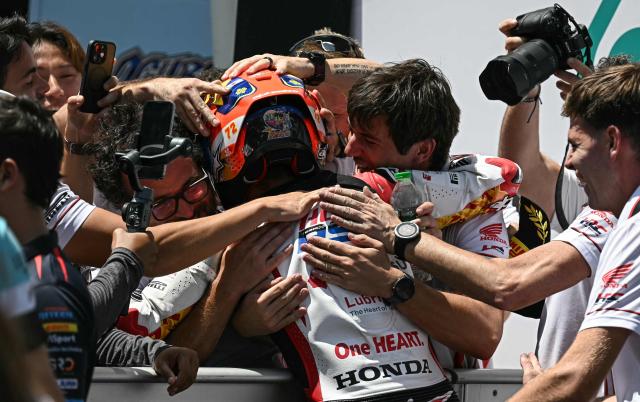 Honda Team Asia team's Japanese Moto3 rider Taiyo Furusato (C) celebrates with his team after winning the Moto3 race at the MotoGP Malaysian Grand Prix at the Sepang International Circuit in Sepang on October 26, 2025. (Photo by Lillian SUWANRUMPHA / AFP)