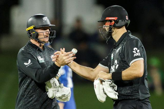 New Zealand's Nathan Smith (L) and Daryl Mitchell react during the first one-day international (ODI) cricket match between New Zealand and England at Bay Oval in Tauranga on October 26, 2025. (Photo by DJ MILLS / AFP)