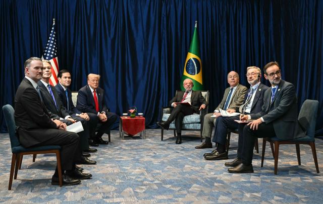 Brazil's President Luiz Inacio Lula da Silva (centre R) holds a bilateral meeting with US President Donald Trump (centre L) on the sidelines of the 47th Association of Southeast Asian Nations (ASEAN) Summit in Kuala Lumpur on October 26, 2025. (Photo by ANDREW CABALLERO-REYNOLDS / AFP)