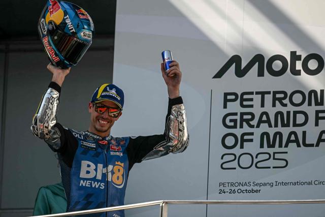 BK8 Gresini Racing MotoGP team's Spanish MotoGP rider Alex Marquez celebrates on the podium after winning the MotoGP Malaysian Grand Prix at the Sepang International Circuit in Sepang on October 26, 2025. (Photo by Lillian SUWANRUMPHA / AFP)