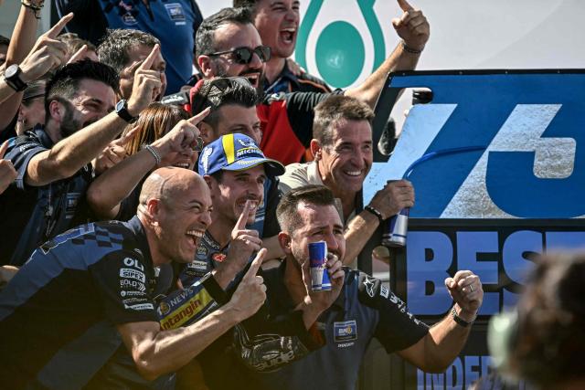 BK8 Gresini Racing MotoGP team's Spanish MotoGP rider Alex Marquez (centre L) celebrates with his team after winning the MotoGP Malaysian Grand Prix at the Sepang International Circuit in Sepang on October 26, 2025. (Photo by Lillian SUWANRUMPHA / AFP)