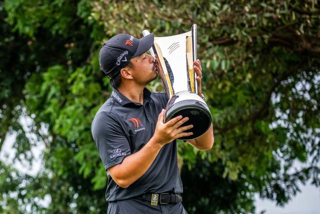 Philippines' Miguel Tabuena kisses the trophy during the presentation ceremony, as he celebrates his win at the International Series Philippines golf tournament in the Sta. Elena Golf Club of Santa Rosa, Laguna province on October 26, 2025. (Photo by Graham Uden / AFP)