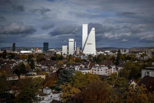 This photograph shows the two towers, designed by Herzog and de Meuron, housing the headquarters of Swiss multinational pharma giant Roche, in Basel on October 26, 2025. US President Donald Trump is pressuring the Swiss pharmaceutical industry to lower its prices in the United States and move its production there, threatening tariffs. (Photo by Fabrice COFFRINI / AFP)