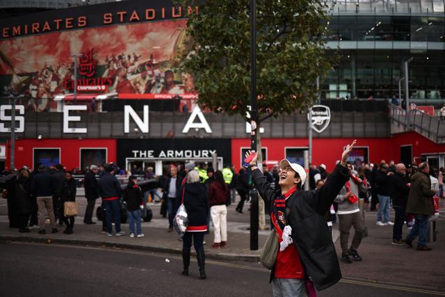 Fans arrive outside the ground ahead of the English Premier League football match between Arsenal and Crystal Palace at the Emirates Stadium in London on October 26, 2025. (Photo by HENRY NICHOLLS / AFP)