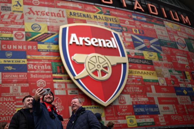 Fans take a selfie photo as they arrive outside the ground ahead of the English Premier League football match between Arsenal and Crystal Palace at the Emirates Stadium in London on October 26, 2025. (Photo by HENRY NICHOLLS / AFP)