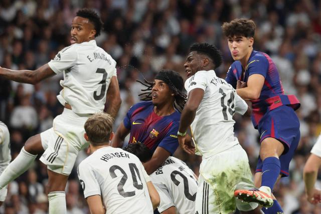 (From L) Real Madrid's Brazilian defender #03 Eder Militao, Barcelona's French defender #23 Jules Kounde, Real Madrid's French midfielder #14 Aurelien Tchouameni and Barcelona's Spanish defender #05 Pau Cubarsi vie for a header during the Spanish league football match between Real Madrid CF and FC Barcelona at Santiago Bernabeu Stadium in Madrid on October 26 , 2025. (Photo by Oscar DEL POZO / AFP)
