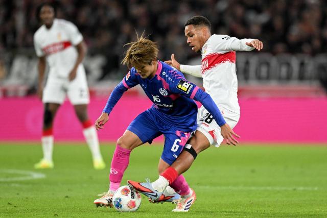 Mainz' Japanese midfielder #06 Kaishu Sano and Stuttgart's Danish midfielder #28 Nikolas Nartey vie for the ball during the German first division Bundesliga football match VfB Stuttgart v Mainz 05 in Stuttgart, southwestern Germany on October 26, 2025. (Photo by THOMAS KIENZLE / AFP) / DFL REGULATIONS PROHIBIT ANY USE OF PHOTOGRAPHS AS IMAGE SEQUENCES AND/OR QUASI-VIDEO