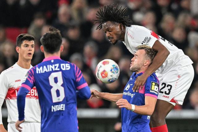 Stuttgart's French defender #23 Dan-Axel Zagadou (R) and Mainz' German forward #17 Benedict Hollerbach vie for the ball during the German first division Bundesliga football match VfB Stuttgart v Mainz 05 in Stuttgart, southwestern Germany on October 26, 2025. (Photo by THOMAS KIENZLE / AFP) / DFL REGULATIONS PROHIBIT ANY USE OF PHOTOGRAPHS AS IMAGE SEQUENCES AND/OR QUASI-VIDEO  ALTERNATIVE CROP