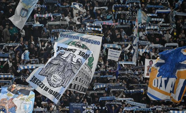 Lazio's supporters wave flags ahead of the the Italian Serie A football match between Lazio and Juventus at Olympic stadium in Rome on October 26, 2025. (Photo by Isabella BONOTTO / AFP)