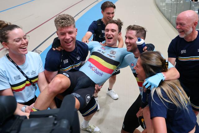 Belgium's Lindsay De Vylder (C L) and Fabio Van den Bossche (C R) celebrate with team members after winning gold in the men's madison 50km event final at the 2025 UCI Track World Championships, in the Penalolen Velodrome in Santiago, on October 26, 2025. (Photo by Javier TORRES / AFP)