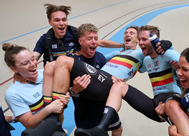 Belgium's Lindsay De Vylder (C L) and Fabio Van den Bossche (C R) celebrate with team members after winning gold in the men's madison 50km event final at the 2025 UCI Track World Championships, in the Penalolen Velodrome in Santiago, on October 26, 2025. (Photo by Javier TORRES / AFP)