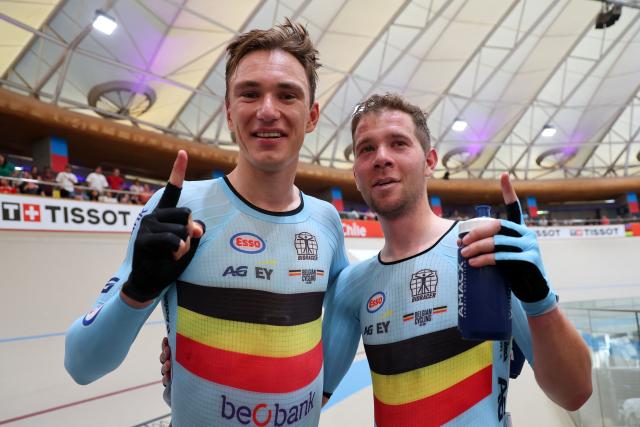 Belgium's Lindsay De Vylder (L) and Fabio Van den Bossche celebrate after winning gold in the men's madison 50km event final at the 2025 UCI Track World Championships, in the Penalolen Velodrome in Santiago, on October 26, 2025. (Photo by Javier TORRES / AFP)