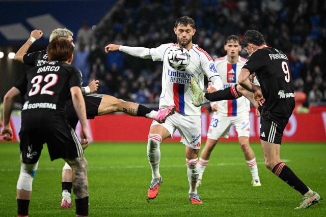 Lyon’s US midfielder #06 Tanner Tessmann (C) fights for the ball with Strasbourg’s Argentinian forward #09 Joaquin Panichelli (R) and Strasbourg’s Paraguayan midfielder #19 Julio Enciso (L) during the French L1 football match between Olympique Lyonnais (OL) and RC Strasbourg Alsace at the Parc Olympique Lyonnais stadium in Decines-Charpieu, central-eastern France, on October 26, 2025. (Photo by OLIVIER CHASSIGNOLE / AFP)