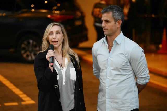 Argentina's General Secretary of the Presidency Karina Milei speaks to the press next to the President of the Chamber of Deputies Martin Menem outside the ruling party's La Libertad Avanza headquarters during the national midterm legislative election, in Buenos Aires on October 26, 2025. Argentines head to the polls for a midterm election that will determine whether President Javier Milei enters the second half of his term bolstered or diminished as economic troubles abound despite unprecedented US aid. (Photo by Luis ROBAYO / AFP)