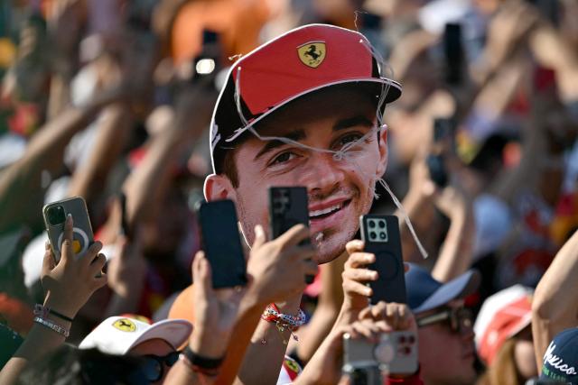 Fans show a sign depicting Ferrari's Monegasque driver Charles Leclerc during the Mexico City Formula One Grand Prix at the Hermanos Rodriguez racetrack in Mexico City on October 26, 2025. (Photo by Carl DE SOUZA / AFP)