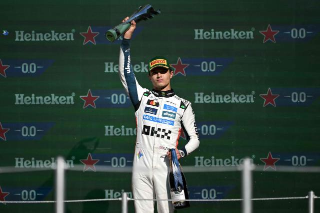 McLaren's British driver Lando Norris lifts the trophy on the podium after winning the Mexico City Formula One Grand Prix at the Hermanos Rodriguez racetrack in Mexico City on October 26, 2025. (Photo by CARL DE SOUZA / AFP)