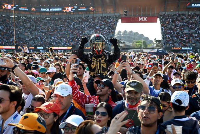 Fans cheer as they wait for the podium ceremony after the Mexico City Formula One Grand Prix at the Hermanos Rodriguez racetrack in Mexico City on October 26, 2025. (Photo by Alfredo ESTRELLA / AFP)