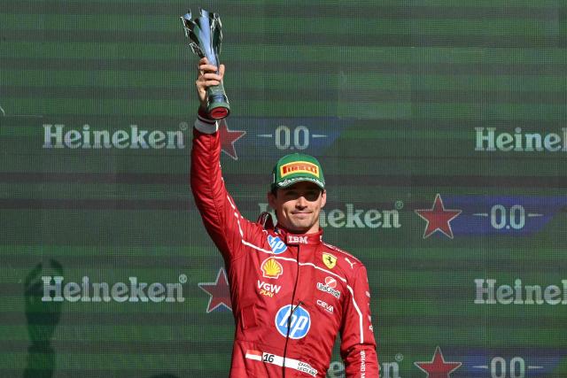 Ferrari's Monegasque driver Charles Leclerc lifts the second place trophy on the podium after the Mexico City Formula One Grand Prix at the Hermanos Rodriguez racetrack in Mexico City on October 26, 2025. (Photo by Yuri CORTEZ / AFP)
