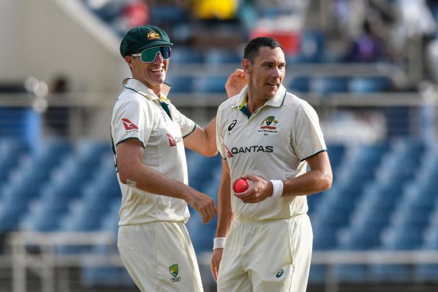 (FILES) Pat Cummins (L) and Scott Boland (R) of Australia celebrate the dismissal of Justin Greaves of West Indies during the 2nd day of the 3rd Test between West Indies and Australia at Sabina Park, Kingston, Jamaica, on July 13, 2025. Injured Australia captain Pat Cummins has been ruled out of the first Ashes Test against England in Perth next month, Cricket Australia said on October 27, 2025 in a statement. (Photo by Randy Brooks / AFP)