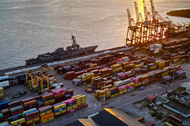 This aerial view shows the USS Gravely warship docked in the port of Port of Spain on October 26, 2025. Venezuela blasted the arrival in nearby Trinidad and Tobago of the US warship as a dangerous "provocation," amid mounting fears of potential attacks against the Venezuelan mainland. (Photo by MARTIN BERNETTI / AFP)