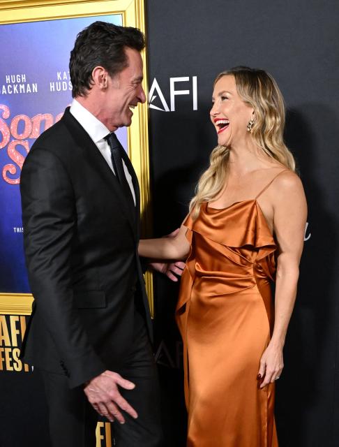 Australian actor Hugh Jackman (L) nd US actress Kate Hudson attend the world premiere of Focus Features’ "Song Sung Blue" during the AFI Fest at the TCL Chinese Theatre in Hollywood, California on October 26, 2025. (Photo by LISA O'CONNOR / AFP)