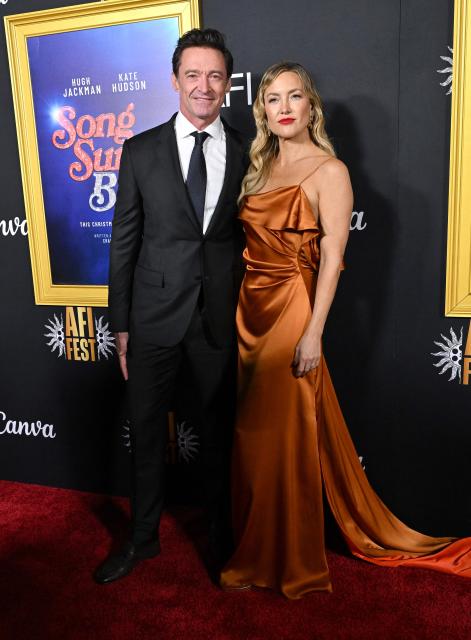 Australian actor Hugh Jackman (L) nd US actress Kate Hudson attend the world premiere of Focus Features’ "Song Sung Blue" during the AFI Fest at the TCL Chinese Theatre in Hollywood, California on October 26, 2025. (Photo by LISA O'CONNOR / AFP)