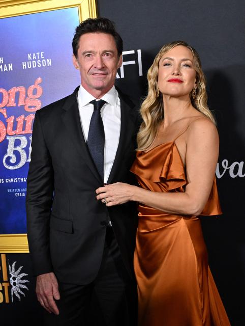 Australian actor Hugh Jackman (L) nd US actress Kate Hudson attend the world premiere of Focus Features’ "Song Sung Blue" during the AFI Fest at the TCL Chinese Theatre in Hollywood, California on October 26, 2025. (Photo by LISA O'CONNOR / AFP)