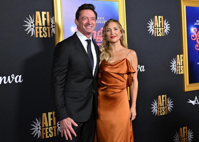Australian actor Hugh Jackman (L) nd US actress Kate Hudson attend the world premiere of Focus Features’ "Song Sung Blue" during the AFI Fest at the TCL Chinese Theatre in Hollywood, California on October 26, 2025. (Photo by LISA O'CONNOR / AFP)