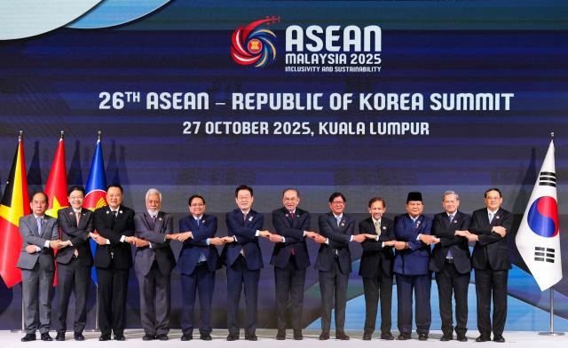 South Korea's President Lee Jae Myung (centre L) poses for a group photo with (from L - R) Myanmar's Permanent Secretary of the Ministry of Foreign Affairs Hau Khan Sum, Singapore’s Prime Minister Lawrence Wong, Thailand's Prime Minister Anutin Charnvirakul, East Timor's Prime Minister Xanana Gusmao, Vietnam's Prime Minister Pham Minh Chinh, Malaysia's Prime Minister Anwar Ibrahim, Philippines' President Ferdinand Marcos Jr., Brunei’s Sultan Hassanal Bolkiah, Indonesia’s President Prabowo Subianto, Cambodia’s Prime Minister Hun Manet and Laos’ Prime Minister Sonexay Siphandone during the 26th ASEAN - South Korea Summit at the 47th Association of Southeast Asian Nations (ASEAN) Summit in Kuala Lumpur on October 27, 2025. (Photo by Hasnoor Hussain / POOL / AFP)