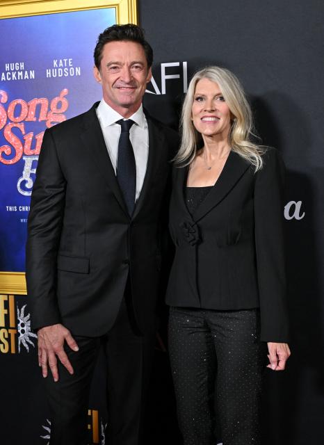 Australian actor Hugh Jackman (L) and Katie McNeil Diamond, US talent manager and wife of US singer-songwriter Neil Diamond, attend the world premiere of Focus Features’ "Song Sung Blue" during the AFI Fest at the TCL Chinese Theatre in Hollywood, California on October 26, 2025. (Photo by LISA O'CONNOR / AFP)