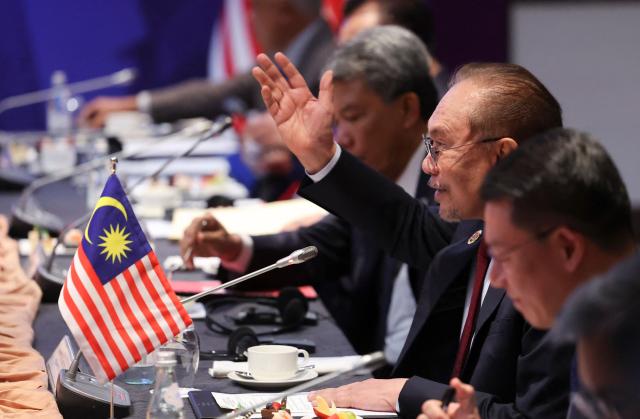 Malaysia's Prime Minister Anwar Ibrahim (2nd R) speaks during a bilateral meeting with South Korea's President Lee Jae Myung on the sidelines of 47th Association of Southeast Asian Nations (ASEAN) Summit in Kuala Lumpur on October 27, 2025. (Photo by Hasnoor Hussain / POOL / AFP)