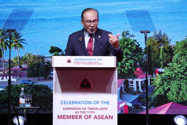 Malaysia's Prime Minister Anwar Ibrahim delivers his speech at a reception to mark East Timor's admission to ASEAN during the 47th Association of Southeast Asian Nations (ASEAN) Summit in Kuala Lumpur on October 27, 2025. (Photo by HOW Hwee Young / POOL / AFP)