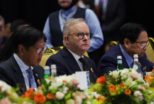 Australia's Prime Minister Anthony Albanese, Philippines' President Ferdinand Marcos Jr (L) and Vietnam's Prime Minister Pham Minh Chinh watch a performance at a reception to mark East Timor's admission to ASEAN during the 47th Association of Southeast Asian Nations (ASEAN) Summit in Kuala Lumpur on October 27, 2025. (Photo by HOW Hwee Young / POOL / AFP)