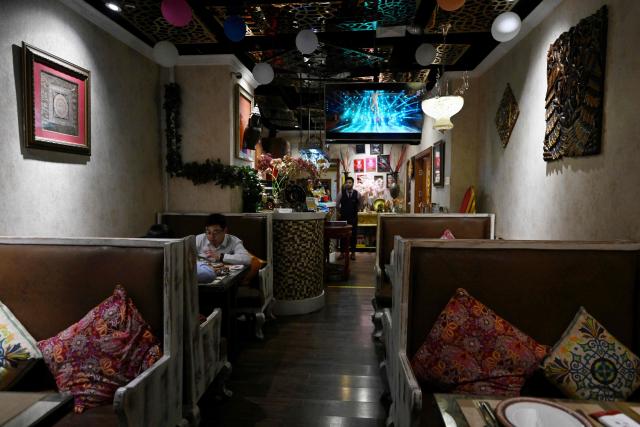 Diners have their lunch at an Indian restaurant in Beijing on October 27, 2025. (Photo by Adek BERRY / AFP)