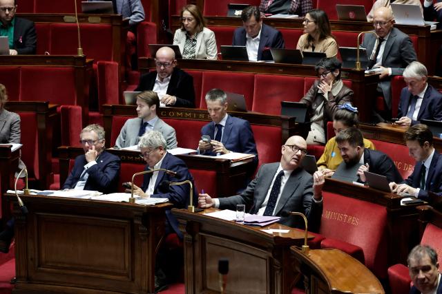 France's Economy and Finance Minister Roland Lescure (down, C), Finance, General Economy, and Budgetary Control Committee General Rapporteur Droite Republicaine's MP Philippe Juvin (down, L) and the committee's President La France Insoumise - Nouveau Front Populaire's MP Eric Coquerel (down, 2nd L) attend the examination a draft finance bill as part of the debate and review of the 2026 State Budget at the French National Assembly, in Paris, on October 27, 2025. (Photo by STEPHANE DE SAKUTIN / AFP)