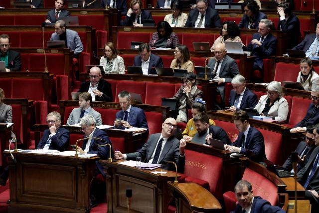 France's Economy and Finance Minister Roland Lescure (down, C), Finance, General Economy, and Budgetary Control Committee General Rapporteur Droite Republicaine's MP Philippe Juvin (down, L) and the committee's President La France Insoumise - Nouveau Front Populaire's MP Eric Coquerel (down, 2nd L) attend the examination a draft finance bill as part of the debate and review of the 2026 State Budget at the French National Assembly, in Paris, on October 27, 2025. (Photo by STEPHANE DE SAKUTIN / AFP)